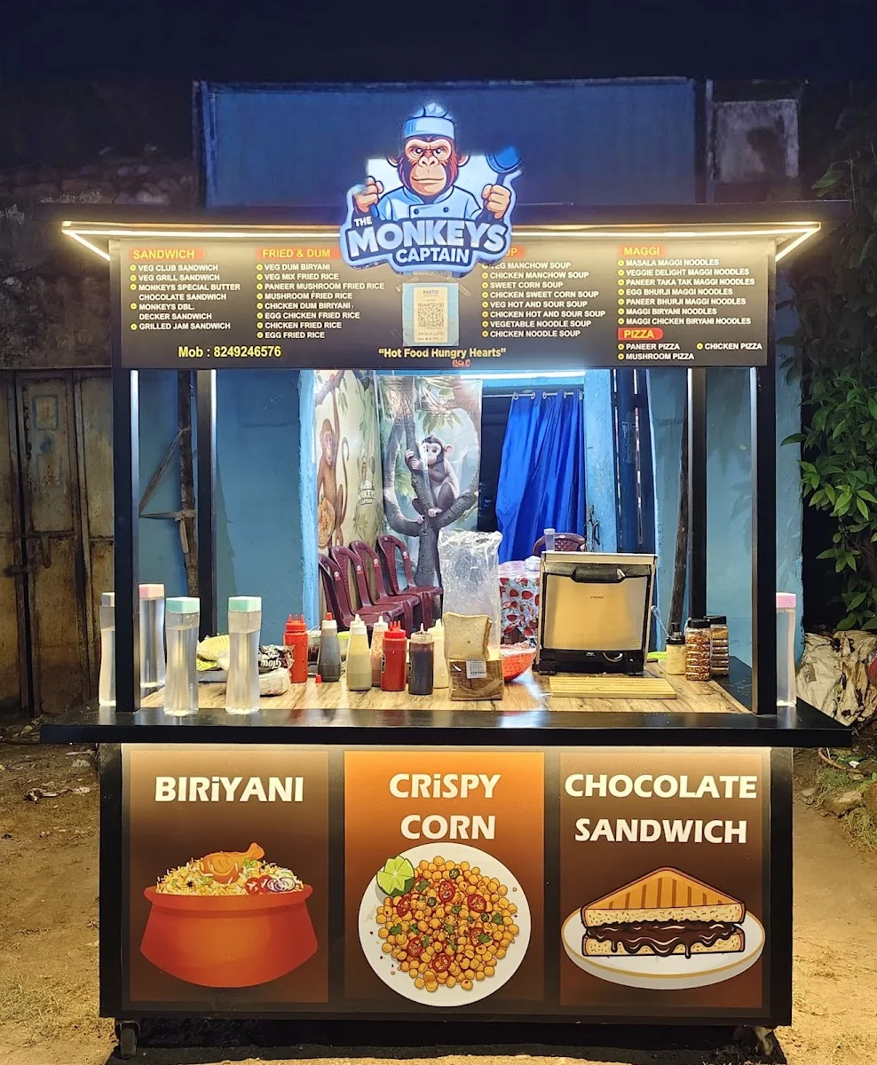 The Monkey's Captain food stall lit up at night